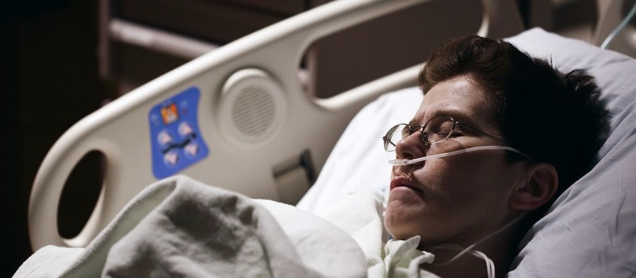 man in hospital bed