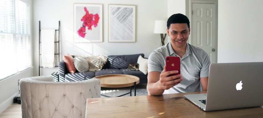 man with computer and phone