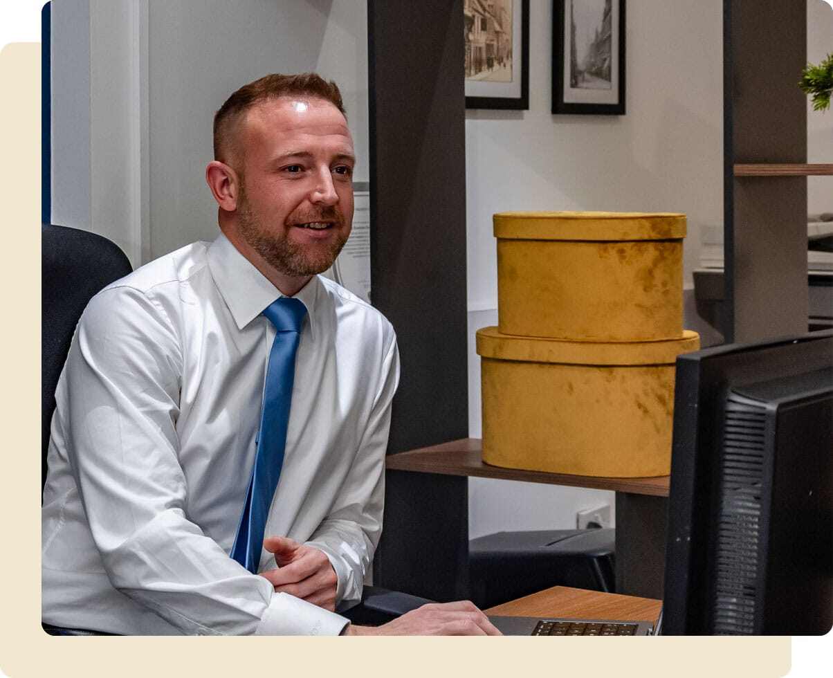 John O'Malley working at his desk typing on his keyboard whilst looking at his monitor