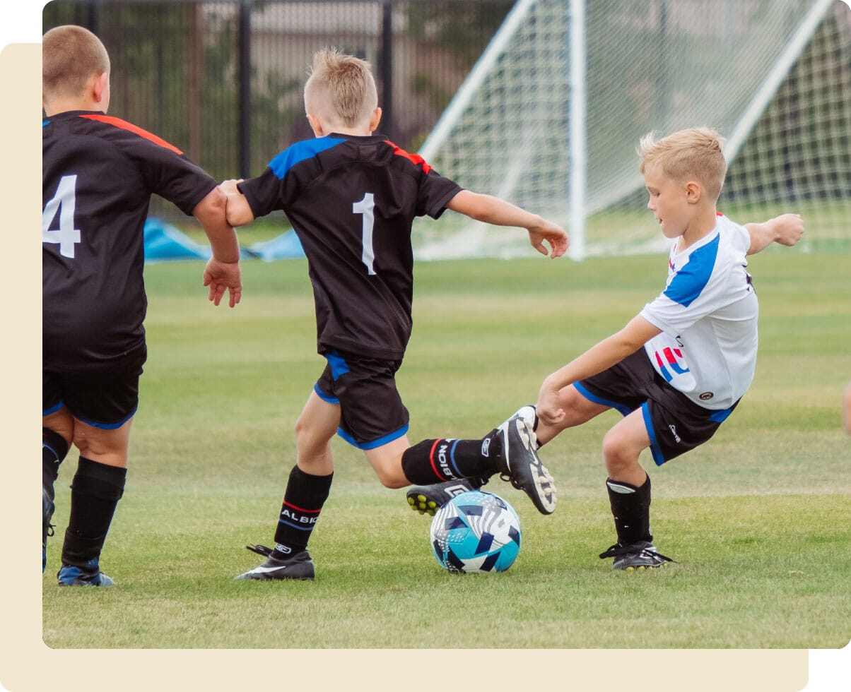 Kids playing a football matching against each other