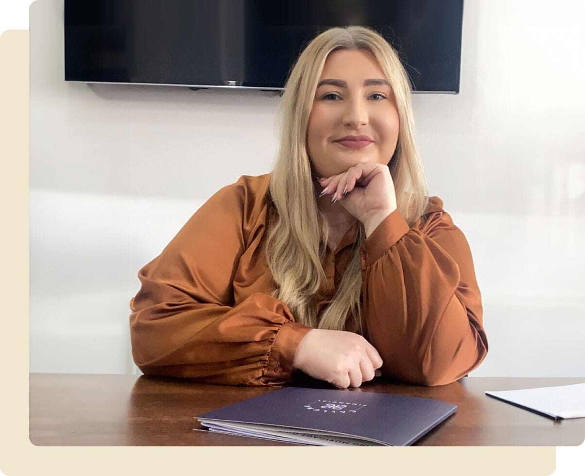 Stephanie English at her office desk looking at the camera