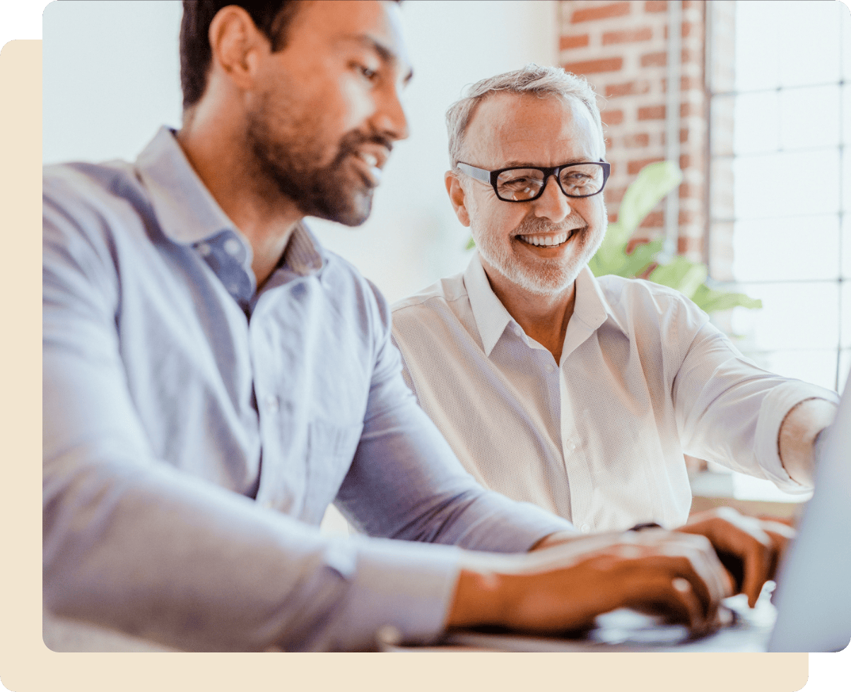 2 men looking at computer screen