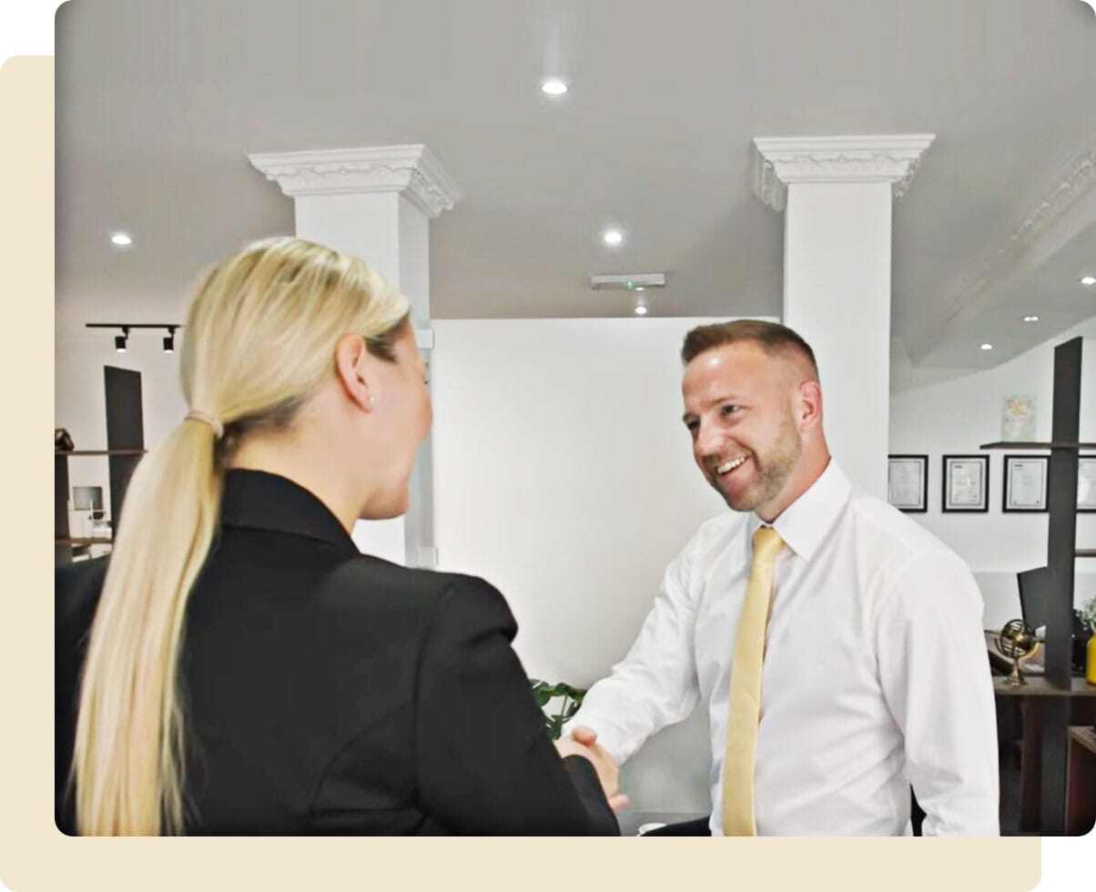 John O'Malley welcoming a new client with a hand shake